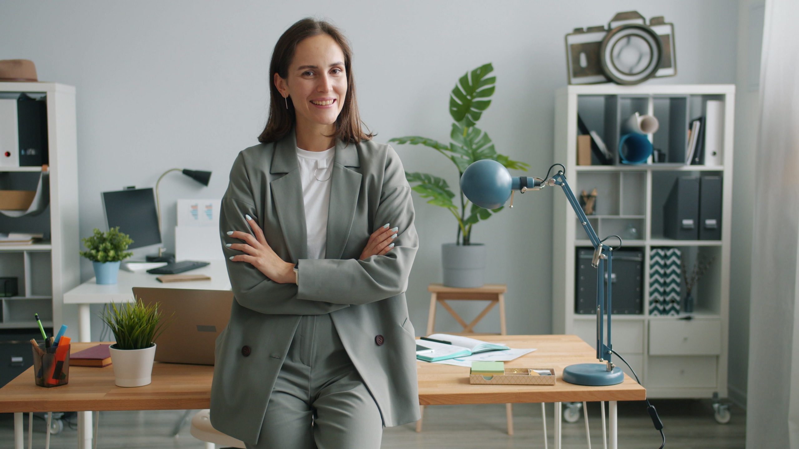 Professional businesswoman smiling confidently in a modern office environment.